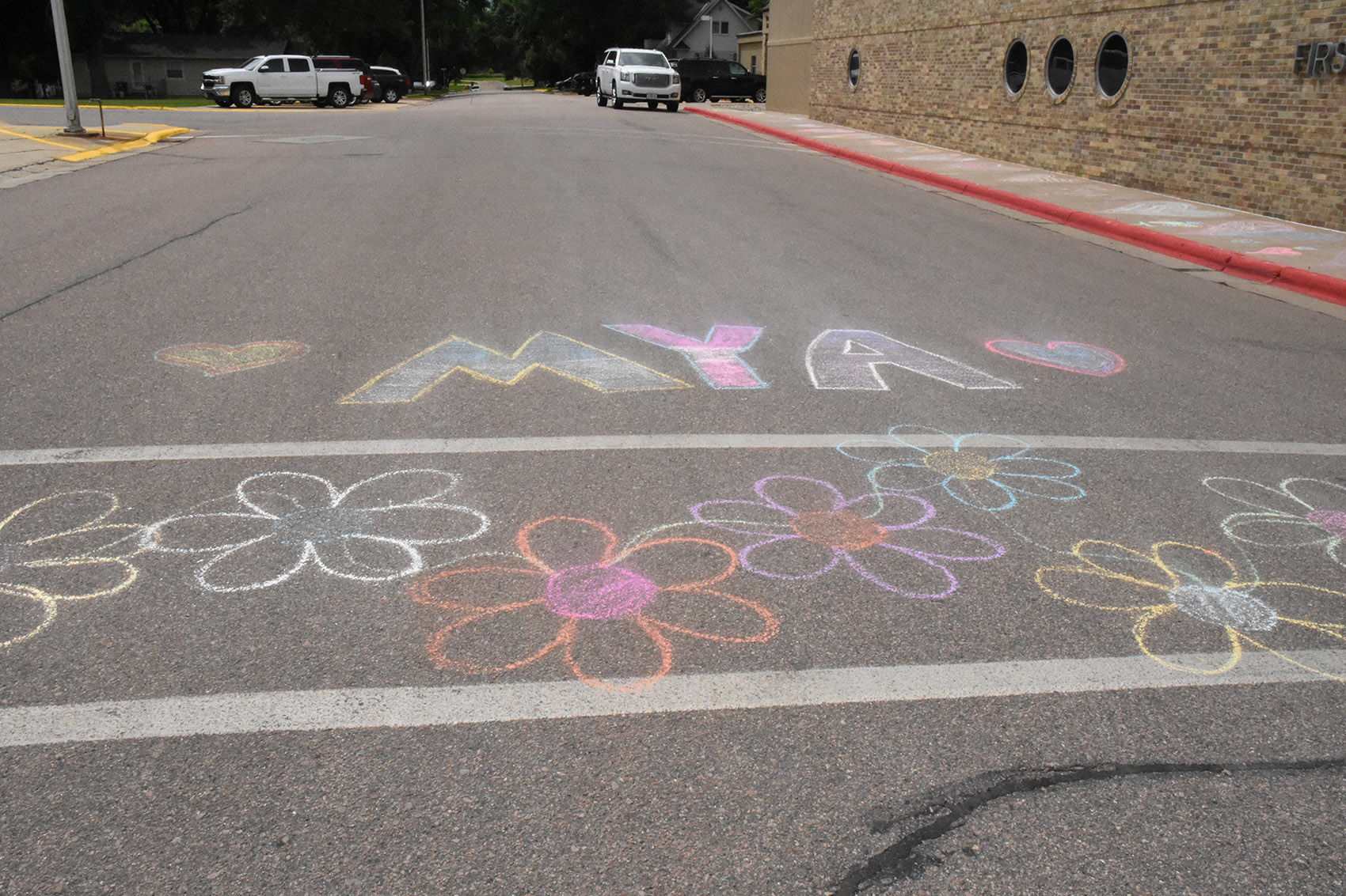 Chalk art at the crosswalk for Mya